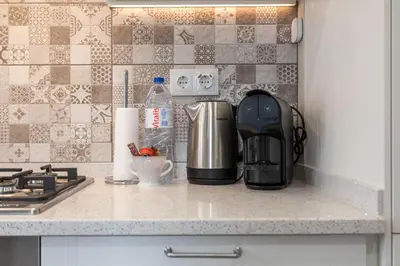 a kitchen counter with a coffee maker on it at Centralgarve - Great, Bright 2-bedroom Flat in the Center of Vilamoura -Topázio in Vilamoura