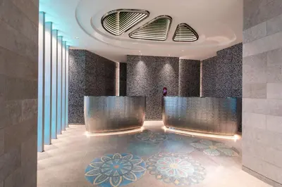 a lobby of a building with a couch and tables at W Algarve in Albufeira