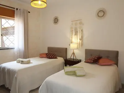 two beds in a room with white walls at Holiday Home Isaurinda by Interhome in Faro