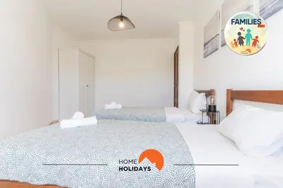 a bedroom with two beds and a sign that reads home holidays at #064 Families Only - Oh Live by Home Holidays in Albufeira
