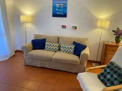 a living room with a couch and two lamps at Solar dos Pinheiros LC 303 in Quarteira