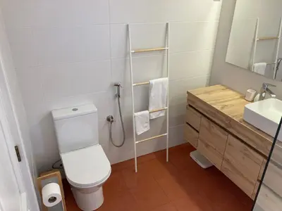 a bathroom with a toilet and a sink and a shower at Solar dos Pinheiros LC 303 in Quarteira