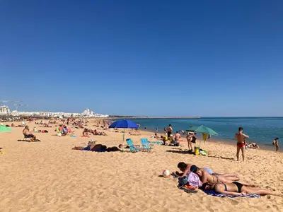 a group of people laying on the beach at Solar dos Pinheiros LC 303 in Quarteira