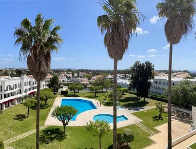 an aerial view of a resort with a swimming pool and palm trees at Apartamentos Ninho das Gaivotas in Albufeira