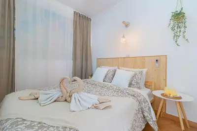 a bedroom with a bed with two towels on it at Sea & Sun OldTown in Albufeira