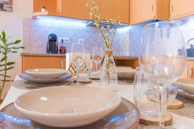 a table with plates and wine glasses on it at Sea & Sun OldTown in Albufeira