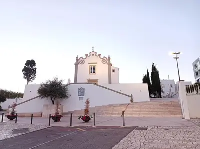 a white church with a steeple and a building at Sea & Sun OldTown in Albufeira