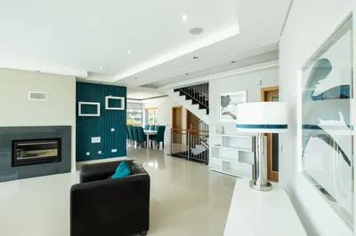 a living room with a black couch and a fireplace at Marina Sol by Atlantic Places in Albufeira