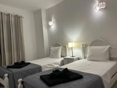 two beds in a hotel room with black towels on them at Sta. Eulalia Mar A36 in Albufeira
