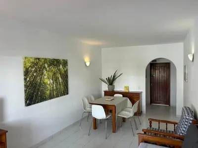 a living room with a table and chairs and a dining room at Sta. Eulalia Mar A31 in Albufeira