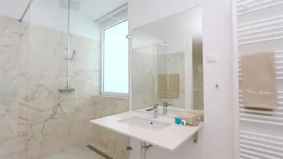 a white bathroom with a sink and a mirror at Villa Sadler- Clever Details, Central Vilamoura, Sleeps 6, luxury, walking distance in Vilamoura
