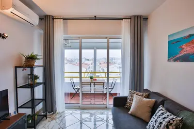 a living room with a couch and a table at Go4Portugal - Lagoa - Apartment 3 min from beach with airco and balcony in Quarteira