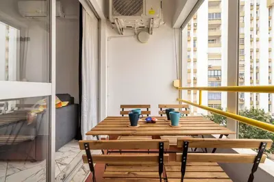a wooden table on a balcony with blue cups on it at Go4Portugal - Lagoa - Apartment 3 min from beach with airco and balcony in Quarteira