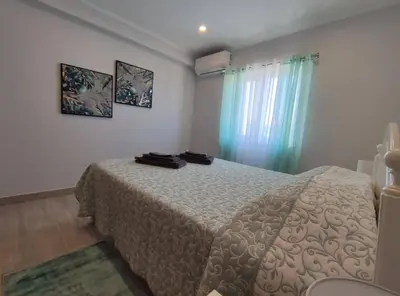 a bedroom with a bed and a window at Alojamento King´s Village in Albufeira