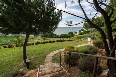 a stairway leading down to a field with the ocean at Pedra dos Bicos by Intiholidays in Albufeira