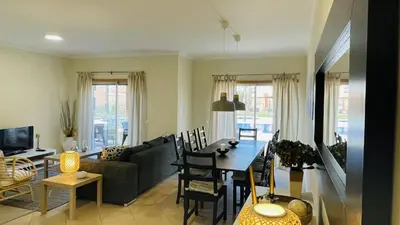 a living room with a couch and a dining room table at Santa Maria G by Check-in Portugal in Albufeira