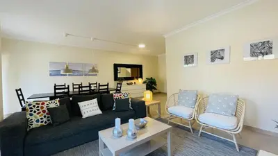 a living room with a black couch and chairs at Santa Maria G by Check-in Portugal in Albufeira
