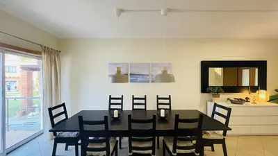 a dining room with a black table and chairs at Santa Maria G by Check-in Portugal in Albufeira