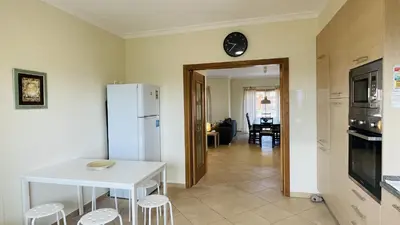 a kitchen with a white table and a white refrigerator at Santa Maria G by Check-in Portugal in Albufeira