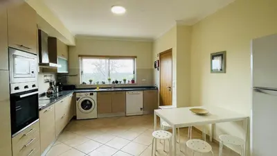 a kitchen with a table and a sink and a stove at Santa Maria G by Check-in Portugal in Albufeira