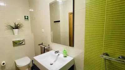 a bathroom with a sink and a shower with a mirror at Santa Maria G by Check-in Portugal in Albufeira