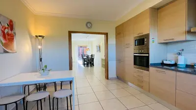 a kitchen with a counter and stools in a room at Santa Maria C by Check-in Portugal in Albufeira