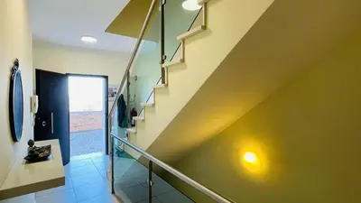 a staircase in a house with a green wall at Santa Maria C by Check-in Portugal in Albufeira