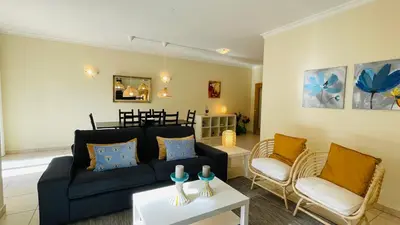 a living room with a blue couch and chairs at Santa Maria C by Check-in Portugal in Albufeira