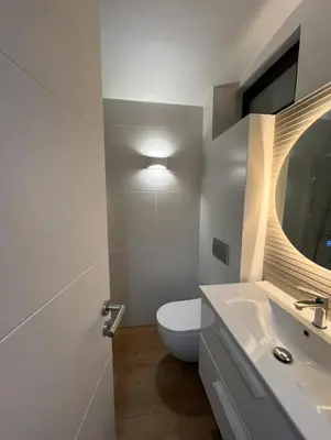 a bathroom with a toilet and a sink and a mirror at Albufeira Garden in Albufeira