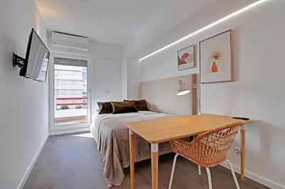 a bedroom with a bed and a table and a bed at Home Out Vilamoura 20 Levante in Vilamoura