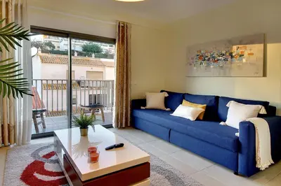 a living room with a blue couch and a table at RoofTop OldTown Residence in Albufeira