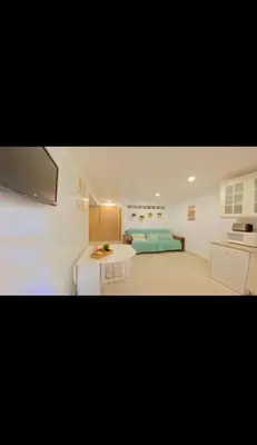 a bedroom with a bed and a table in a room at Casa da Bertha in Albufeira