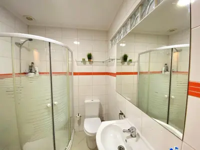 a bathroom with a sink and a shower and a toilet at Casa da Bertha in Albufeira
