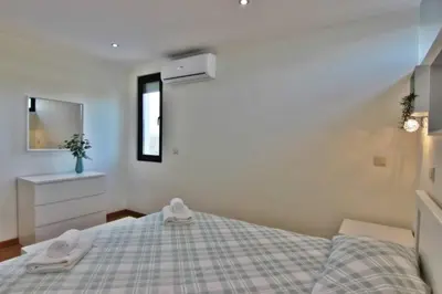 a bedroom with a bed with two towels on it at Pé do Lago Apartment - Condominium - Pool in Quarteira