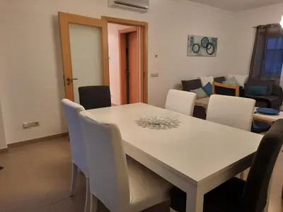 a dining room with a table and chairs at Casa Mandala, T1 com piscina in Albufeira