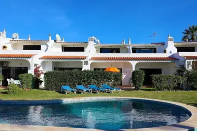 two pools in a yard with palm trees and buildings at Aldeia Joinal - Swimming Pool - FREE WIFI - BY BEDZY in Albufeira