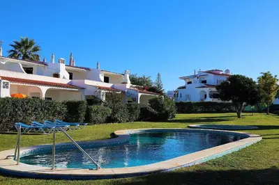 a bedroom with a bed with a gold headboard and two lamps at Aldeia Joinal - Swimming Pool - FREE WIFI - BY BEDZY in Albufeira
