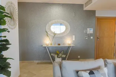 a living room with two chairs and a table with candles at Marina Vilamoura - Aquamar 217 - By Vilamoura Sun in Quarteira