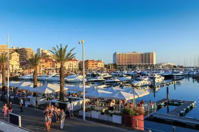 a marina with manyocked boats and people walking around at VilamouraSun Aquamar 406 - Vista Marina in Quarteira