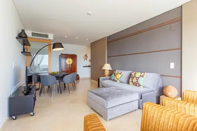 a living room with a couch and a table at VilamouraSun Aquamar 406 - Vista Marina in Quarteira