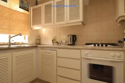 a kitchen with white cabinets and a sink and a stove at Ocean Dream 84 - Apt. T1 na Praia de São Rafael, Albufeira in Albufeira