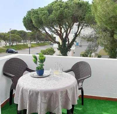 a table with a white table cloth on a balcony at Apartamento Medusa by Sunnyway in Olhos de Água