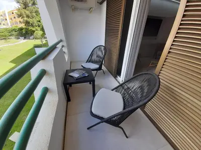 two chairs and a table on a balcony at Apartamento Albufeira Prestige by Sunnyway in Albufeira