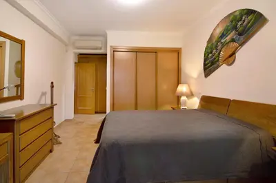 a hotel room with two beds and a table at Vilamoura Tenis 58 in Quarteira