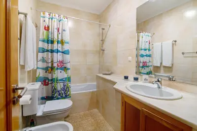 a bathroom with a toilet and a sink and a shower at Vilamoura Tenis 58 in Quarteira