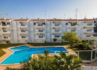 an apartment with a swimming pool in front of a building at Santa Eulália 2-Bedroom Apartment - Swimming Pool - Wifi in Albufeira