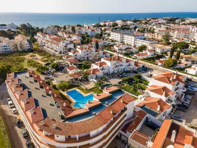 an aerial view of a city with buildings and the ocean at Santa Eulália 2-Bedroom Apartment - Swimming Pool - Wifi in Albufeira