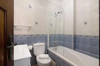 a bathroom with a toilet and a bath tub at Apartamento Old Village T2 Duplex in Quarteira
