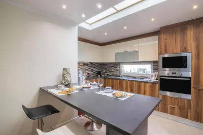 a kitchen with a table with food on it at Apartamento Malick by Sunnyway in Branqueira