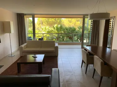 a living room with a couch and a table at Salgados - Vila das Lagoas in Guia